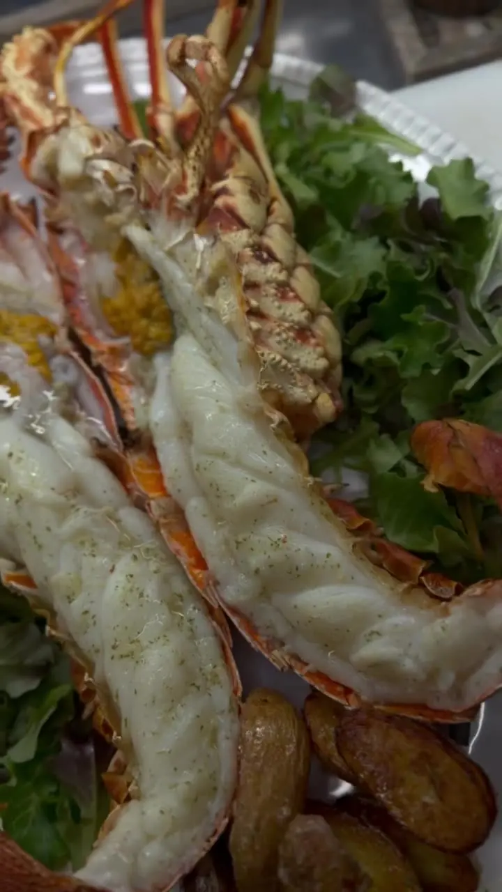 A grilled spiny lobster split in half