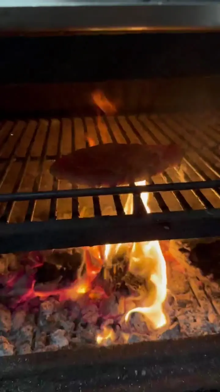 Flames rising from the charcoal grill